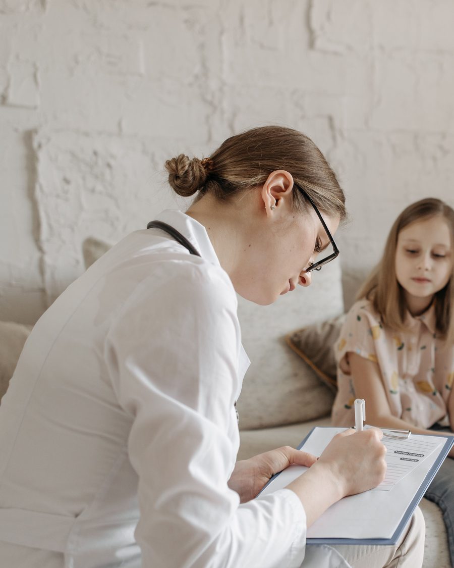 A doctor consulting with a patient in a warm, welcoming room at Klinik Ceria