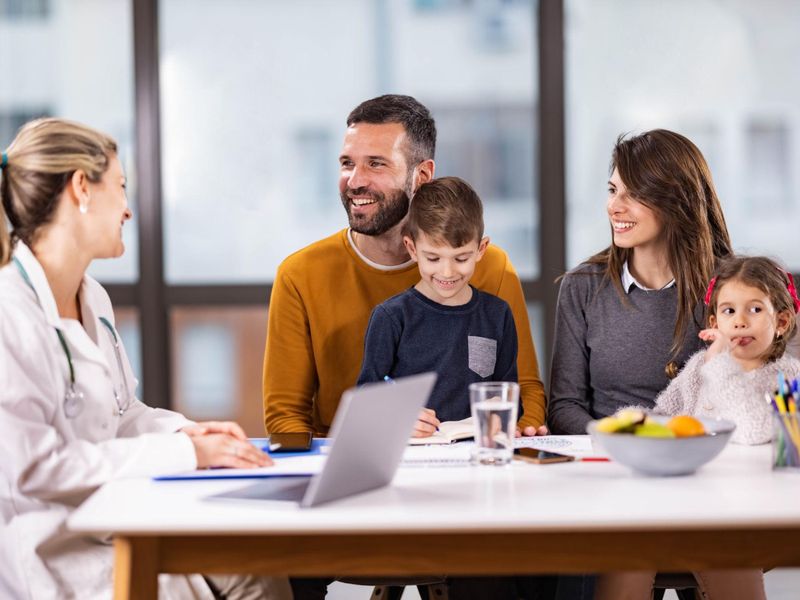 A family consulting with a doctor at Klinik Ceria