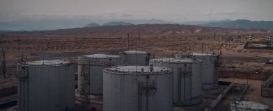 Industrial storage tanks in a desert refinery setting