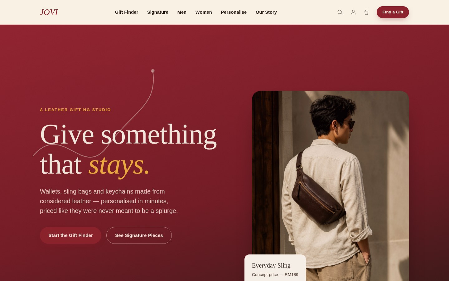 JOVI concept homepage hero with the headline 'Give something that stays.' over a deep maroon editorial colour-block, beside an editorial photograph of the Everyday Sling worn cross-body