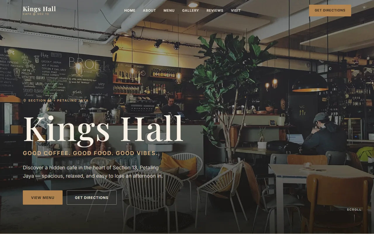 King's Hall Cafe concept homepage hero with a full-bleed interior photograph and a warm brass-and-charcoal palette